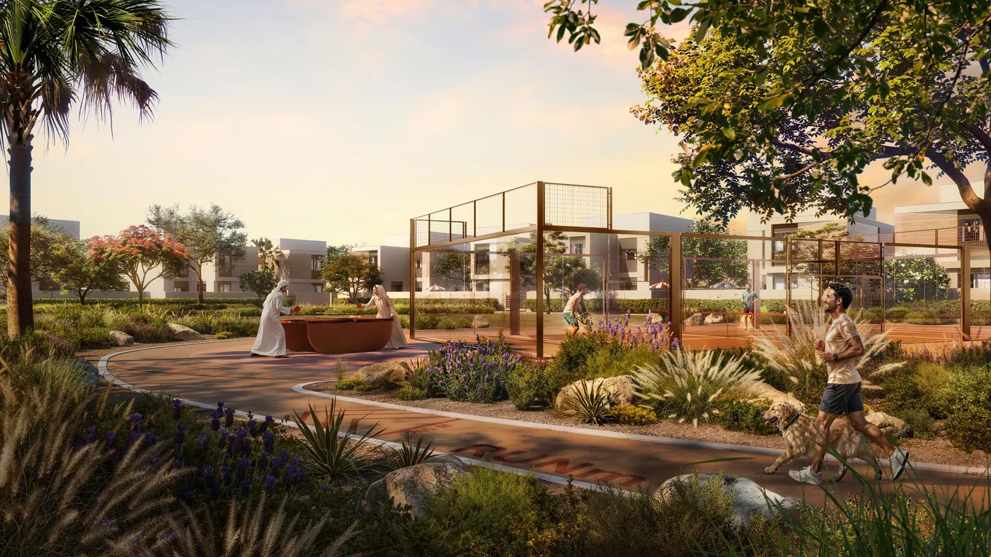 A shaded pedestrian path winding through planted gardens